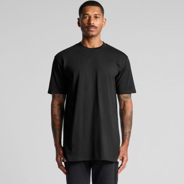 A black classic plus tee with short sleeves, featuring a logo, displayed on a model.