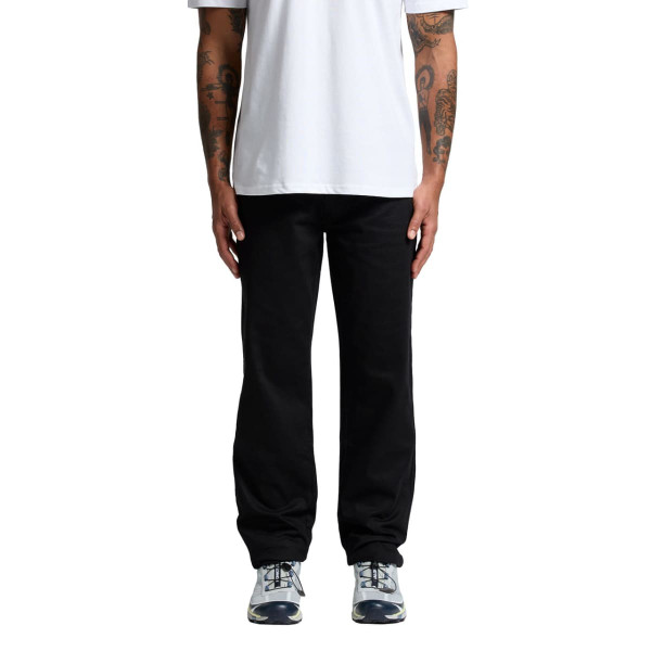 Black relaxed pants worn by a person standing, paired with a plain white t-shirt and athletic shoes.