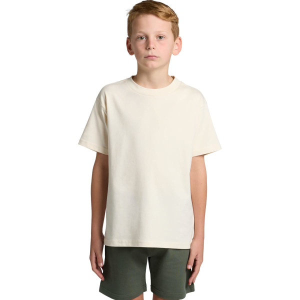 A plain cream youth classic tee with short sleeves, paired with dark green shorts. Features a logo on the tee.