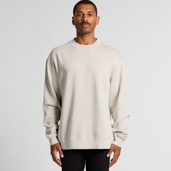 A beige crew jumper featuring long sleeves and a relaxed fit, displayed on a model against a neutral backdrop.