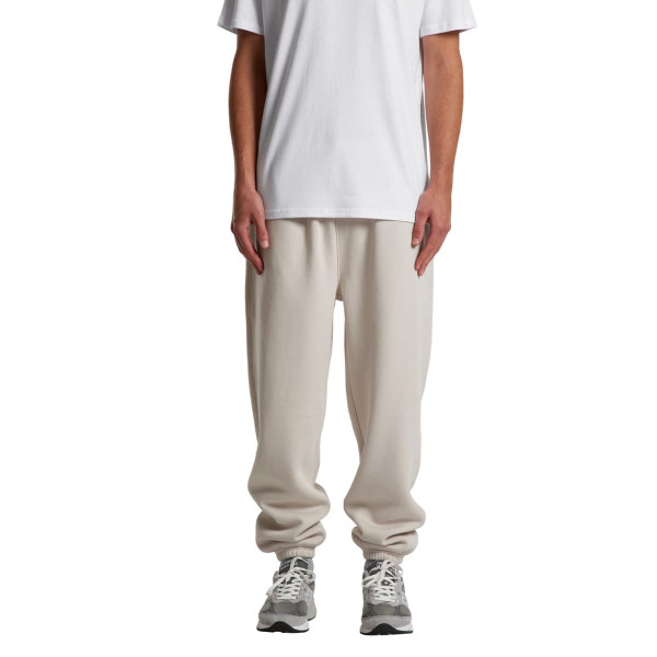 Relax Track Pants in a light cream colour, featuring a loose fit and an elastic waistband, paired with a plain white t-shirt.