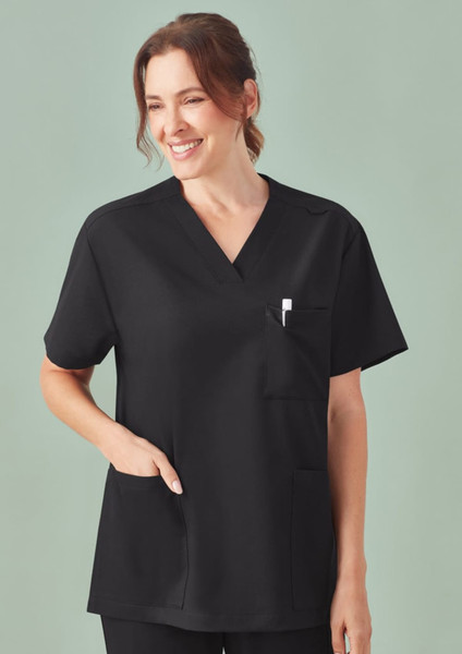 A unisex black V-neck scrub top featuring short sleeves and a pocket. The model is smiling against a soft green background.