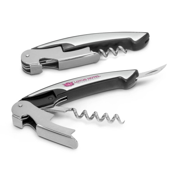 A drink bottle opener featuring a black handle with silver metal components, including a corkscrew and knife. It has branding on the handle.