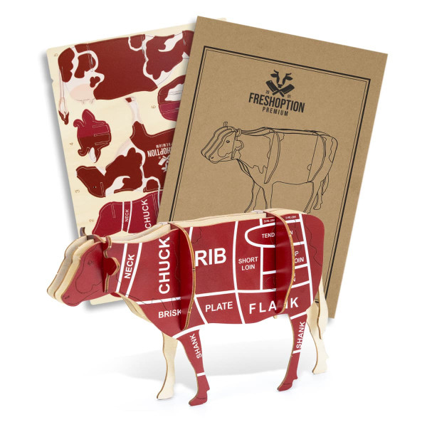 A wooden model of a cow in red and cream, featuring anatomical cuts, accompanied by two instructional booklets.