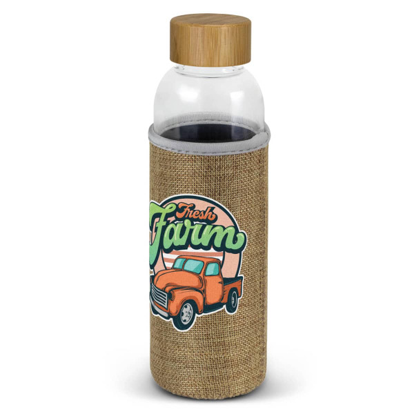 A drink bottle with a clear body, bamboo lid, and a natural fabric sleeve featuring a truck design.