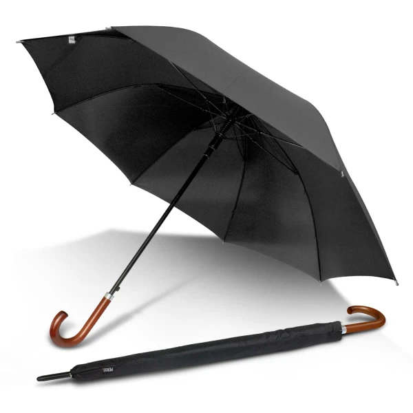 A black executive umbrella with a curved wooden handle, partially opened, alongside its folding cover.