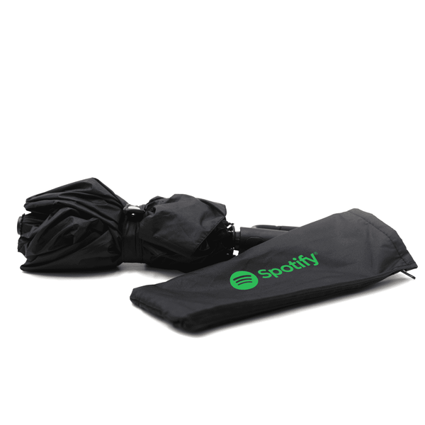 A foldable black umbrella with a black carrying sleeve featuring a logo.