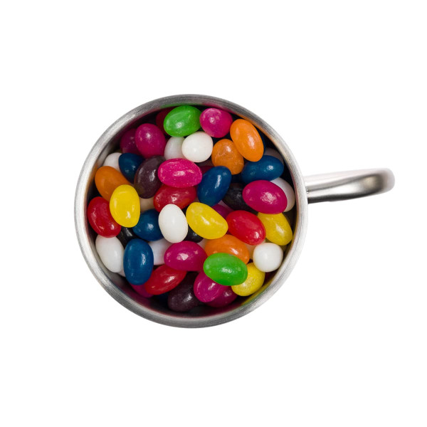 A Java mug filled with assorted mini jelly beans in vibrant colors, including pink, yellow, green, and blue.