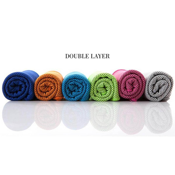 A collection of rolled cooling towels in blue, orange, green, pink, and grey, displayed in a row with a reflective surface.