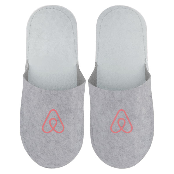 Grey felt slippers featuring a logo on the front, designed for comfort and cosy wear.