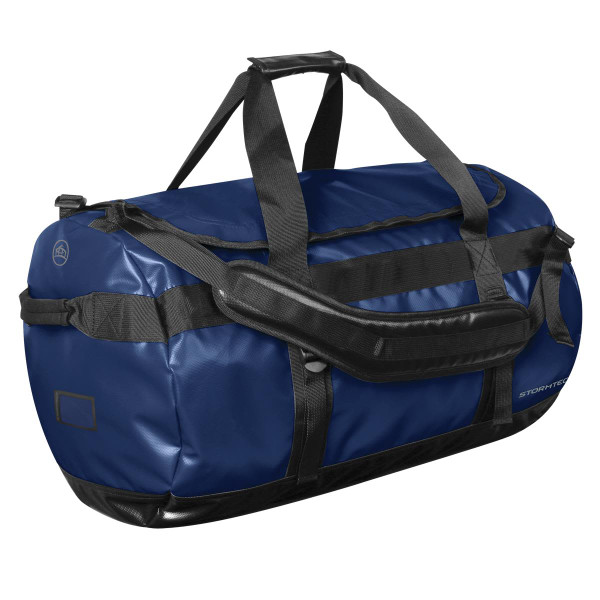 A large navy blue duffle bag with black straps and a branding logo.