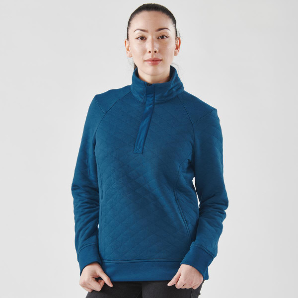 A teal women's thermal pullover with a 1/4 zip and a quilted pattern, featuring a logo on the front.