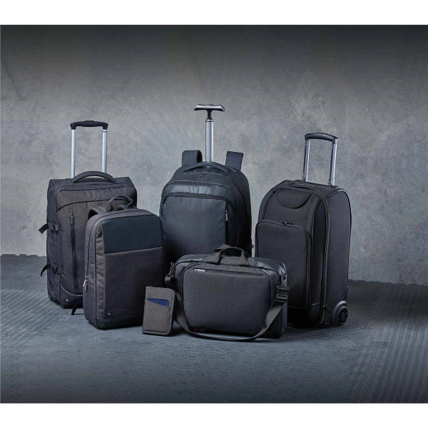 A collection of black bags, including backpacks, a wheeled suitcase, and a messenger bag, with a sleek design.