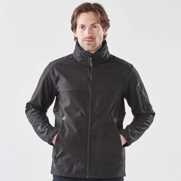 A men's black softshell jacket with a full zip, featuring zippered pockets and a stand-up collar.
