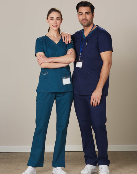 Two individuals wearing solid colour scrub pants—one in teal and the other in navy—standing side by side.