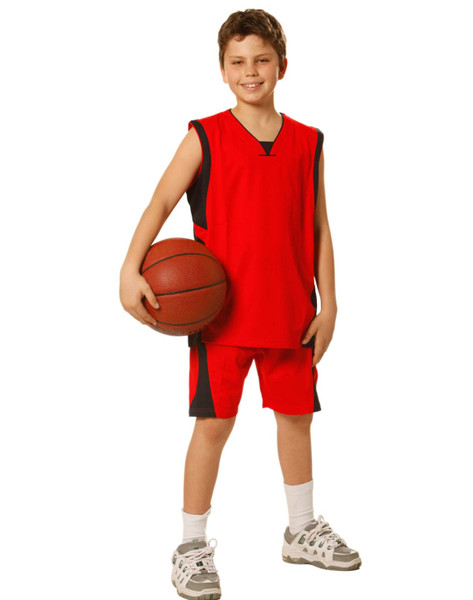 A red kid's basketball singlet and shorts set, featuring black accents, held by a child with a basketball.