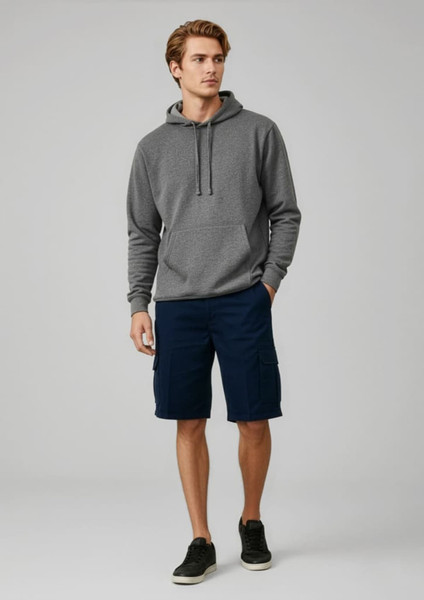 A man wearing a grey hoodie and navy shorts stands casually. The shorts feature pockets and a logo.