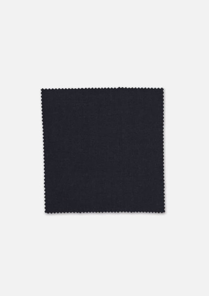 A square swatch of dark navy wool stretch suiting fabric with a textured finish and scalloped edges.