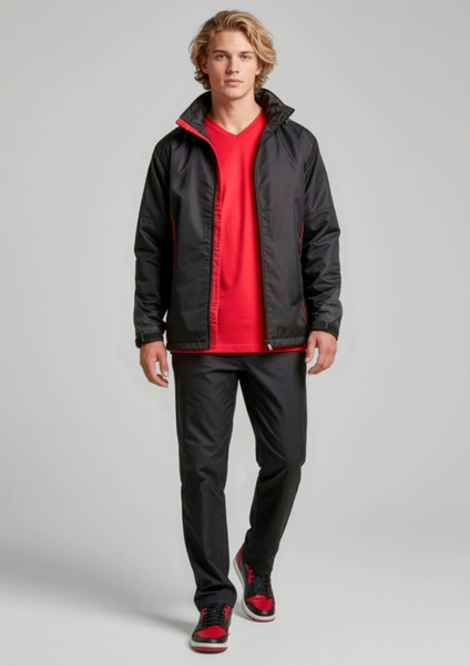 A model wears black track pants with a matching jacket and a red t-shirt, featuring a logo.