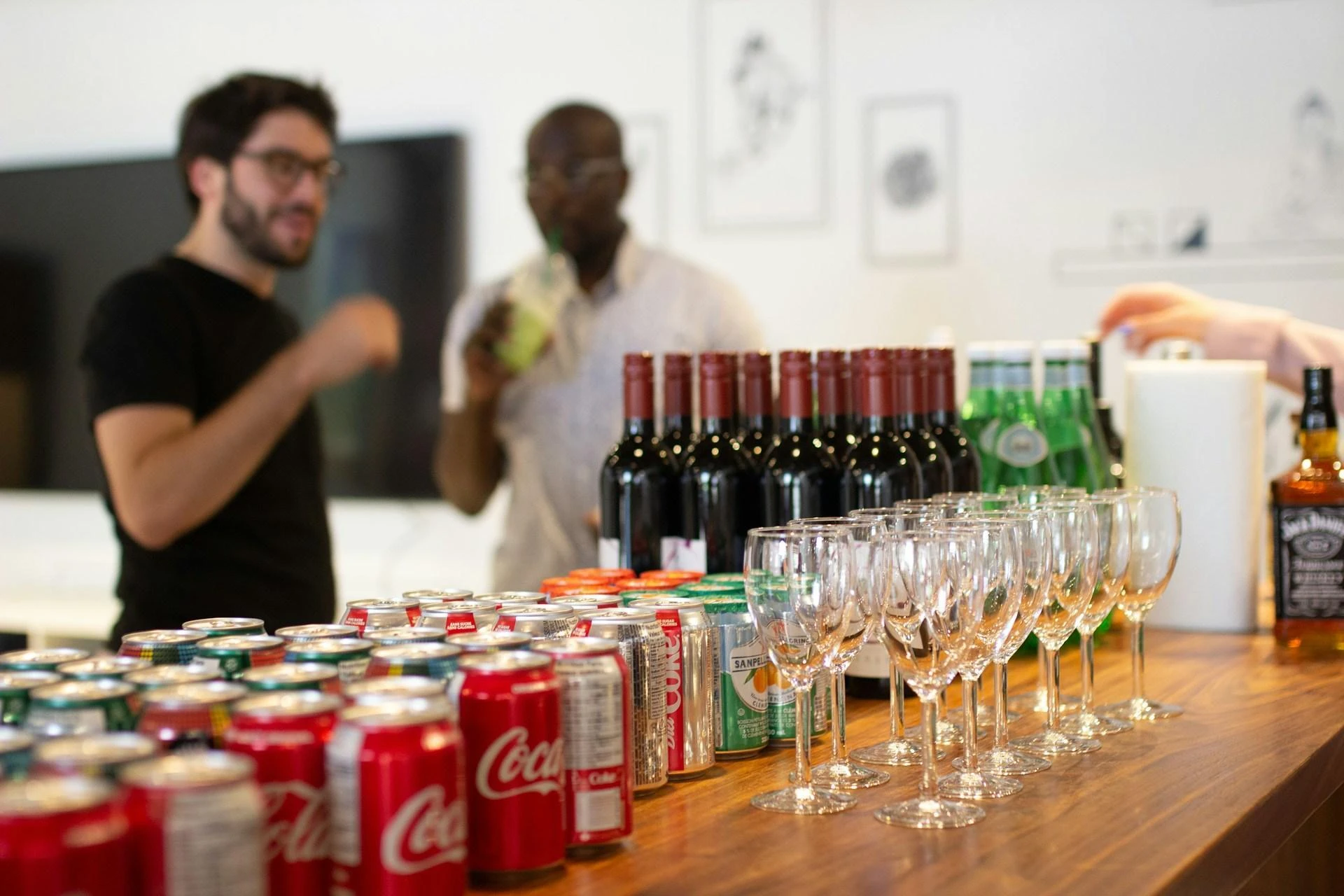 An office Christmas party with an array of free drinks, cans, and wine bottles