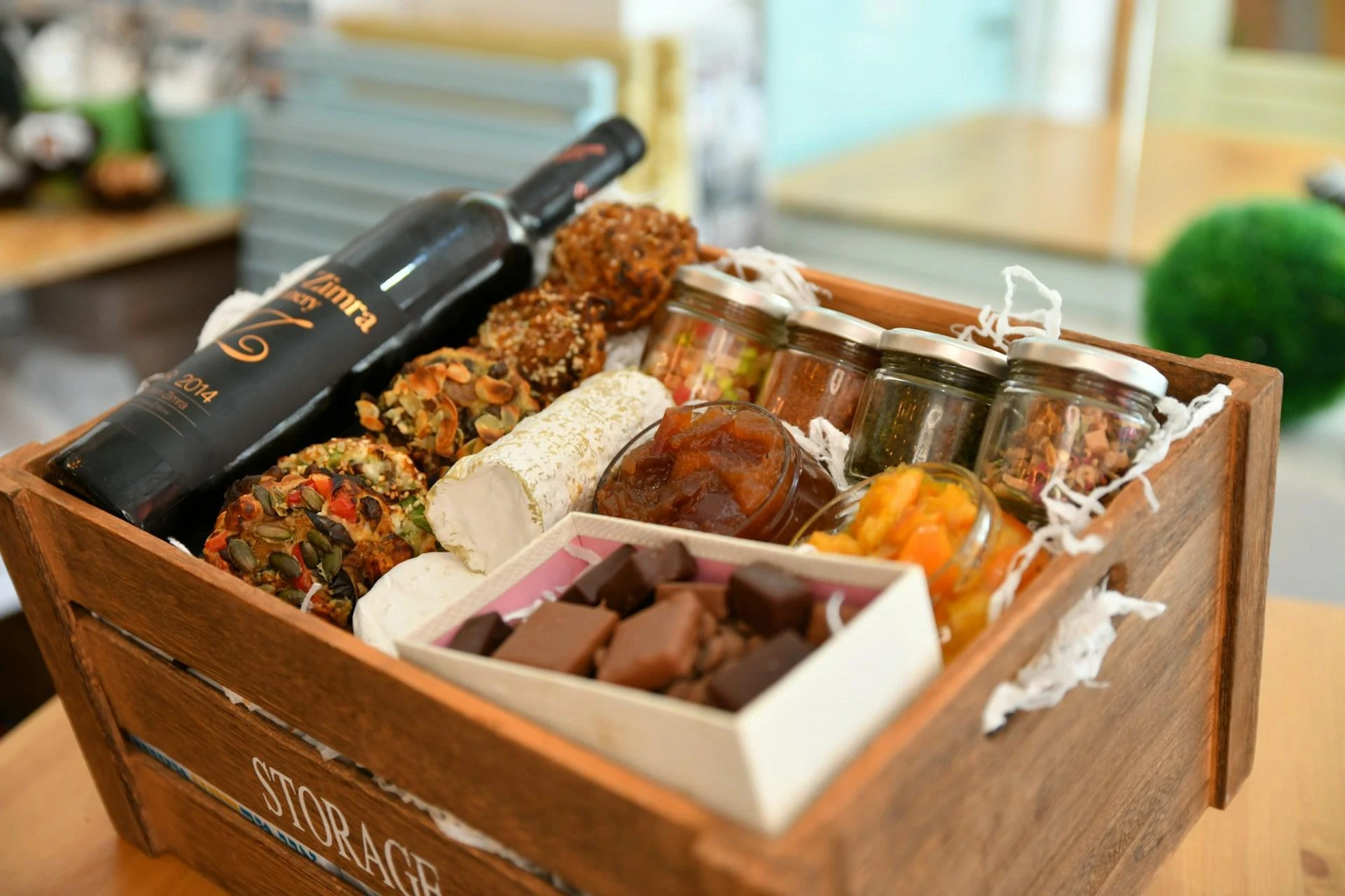 A luxury Christmas hamper filled with pots of food, chocolatges, and wine