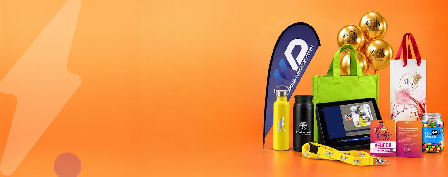 Branded conference lanyards, tote bags and drink bottles laid out for an event giveaway