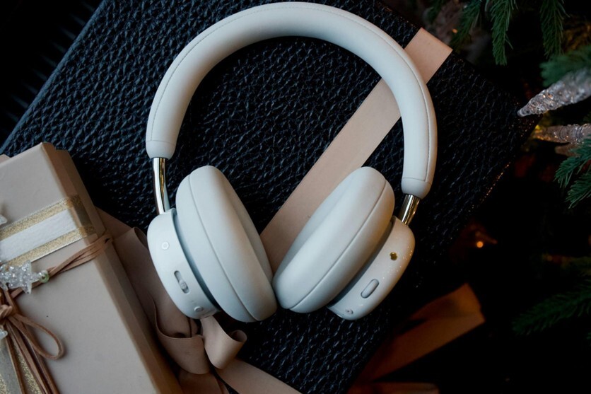 A pair of white, premium-looking headphones surrounded by gift wrapping