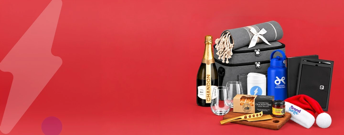 Christmas-themed branded gifts including drinkware and desk items wrapped for corporate giving