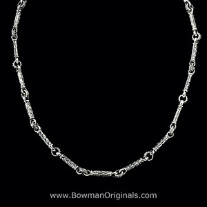 View of handmade Sterling Silver Leaf Bar Chain Link Layering Necklace. 1/4 in and 1/8 in wide links. By Bowman Originals.
View of handmade Sterling Silver Leaf Bar Chain Link Layering Necklace. 1/4 in and 1/8 in wide links. By Bowman Originals.