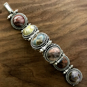This bold handmade Sterling Silver Multi Stone Bracelet features a series of large, inline cabochons creating a stunning display of color while it's substantial size and powerful presence make it a statement piece. USA. Call or text 941-302-9594. www.BowmanOriginals.com This bold handmade Sterling Silver Multi Stone Bracelet features a series of large, inline cabochons creating a stunning display of color while it's substantial size and powerful presence make it a statement piece. USA. Call or text 941-302-9594. www.BowmanOriginals.com