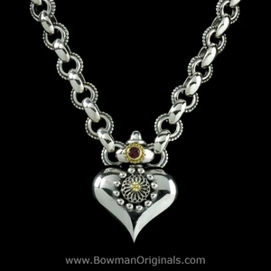Close up of Handcrafted Sterling Silver, 18k Gold and Garnet chain link Heart Necklace by Bowman Originals in Sarasota, Fl.
