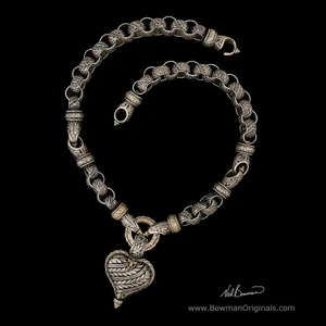 Handmade Laurel Leaf reversible heart necklace in Sterling Silver and 18k Yellow Gold with engraved design and vitreous enamel.