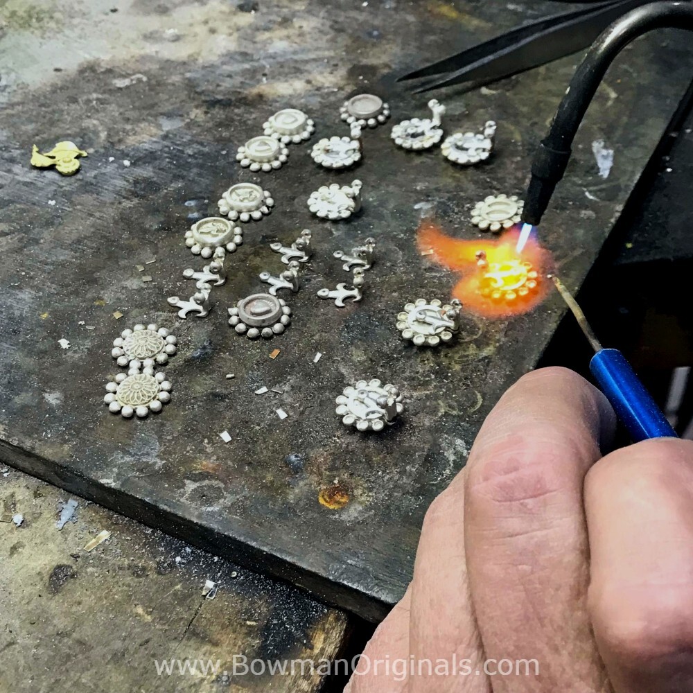 Ned Bowman soldering handmade Sterling Silver earrings for the Earring Collection on his work bench at Bowman Originals.