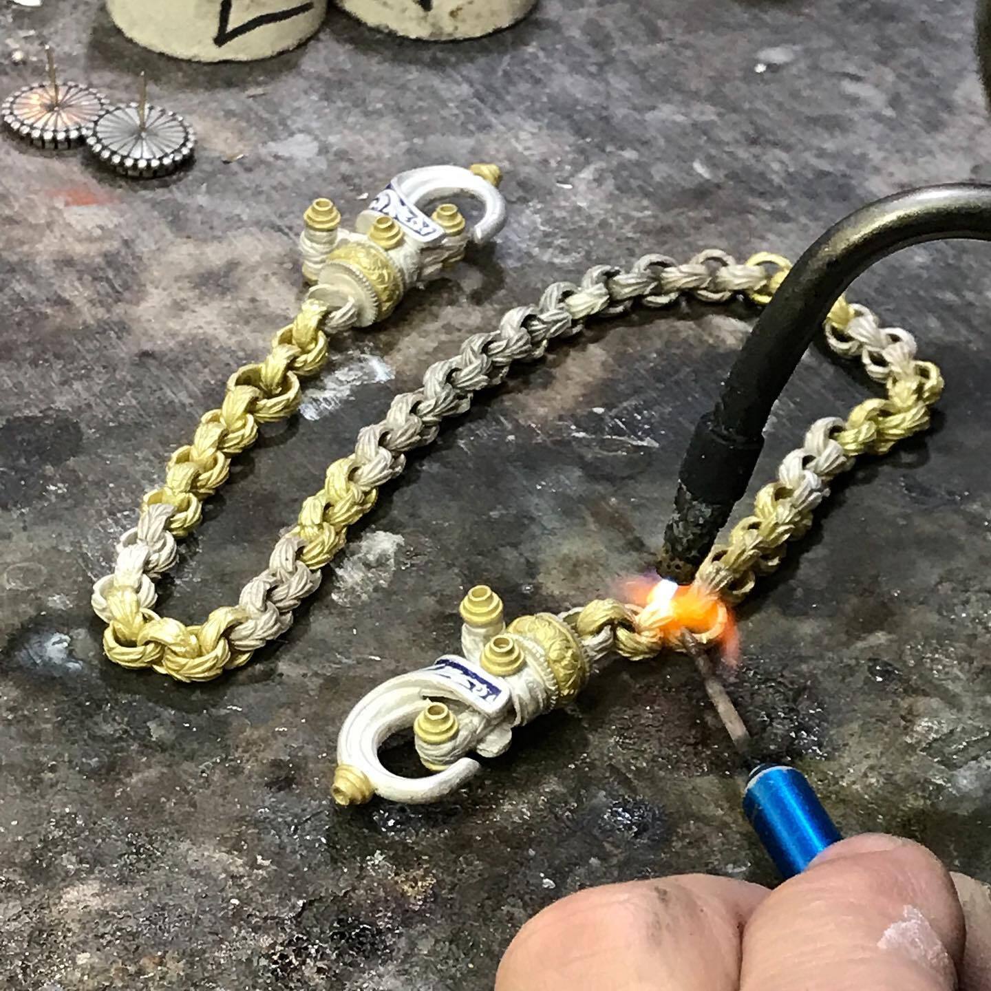Soldering handmade Sterling Silver and 18k Gold chain links in the Bowman Originals workshop