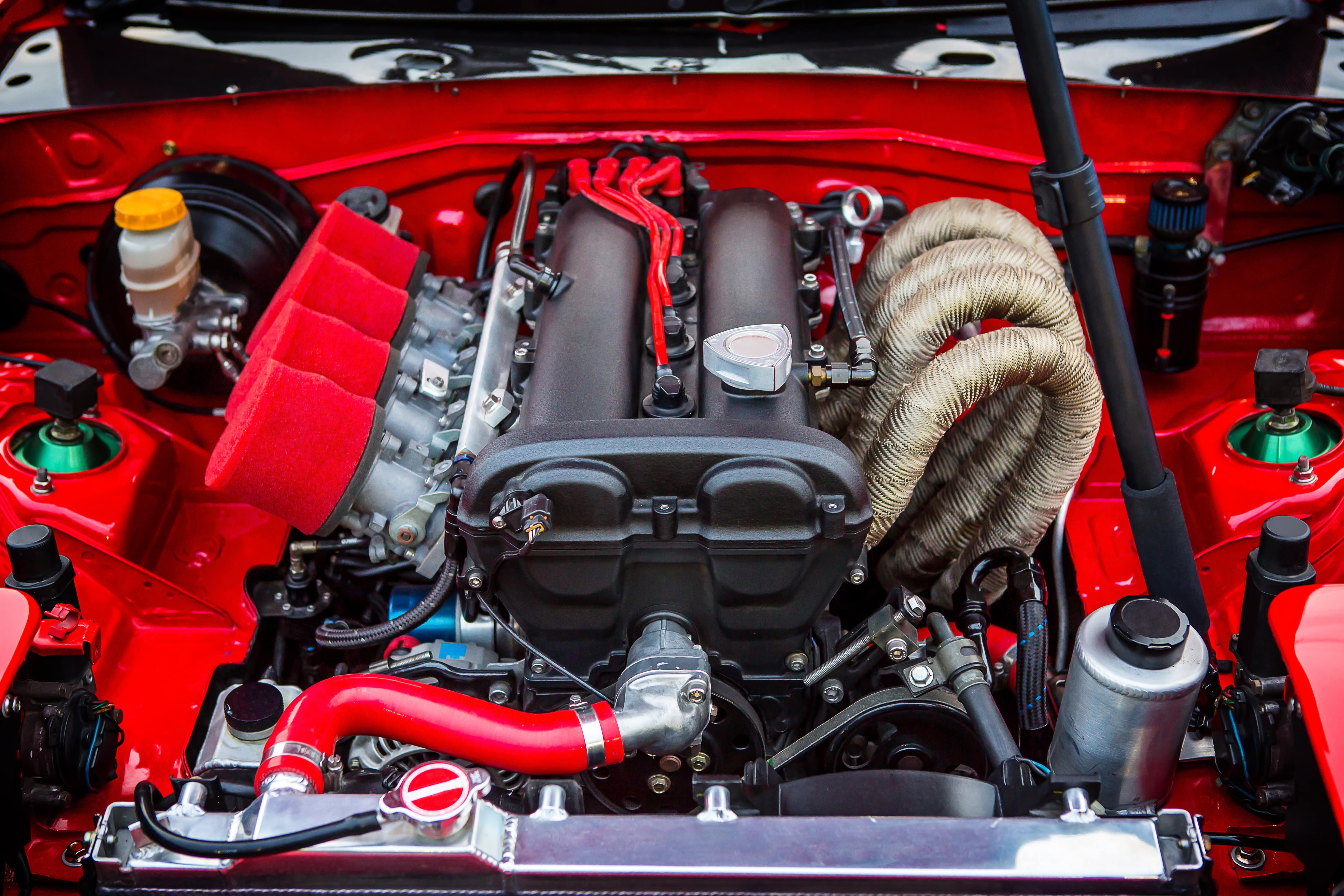 view under the hood of a red vehicle