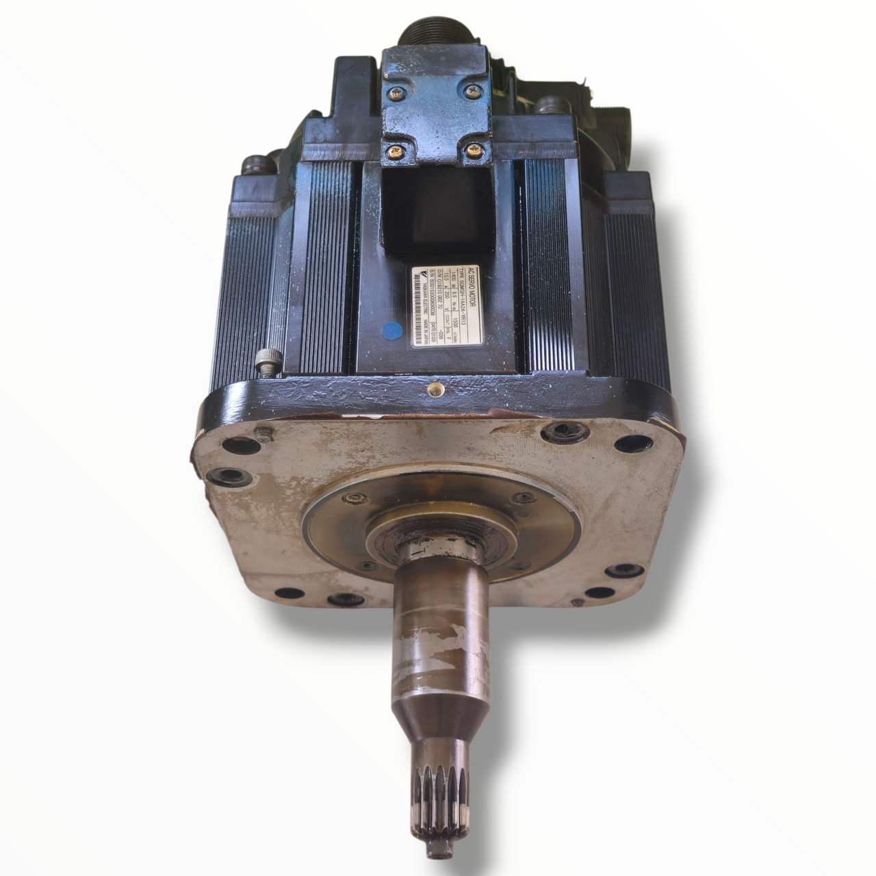 The motor shaft is splined gear type, showing some signs of wear and use.

Mounting plate has scratches and discoloration from previous installation.

Four mounting holes around the shaft are visible and intact.