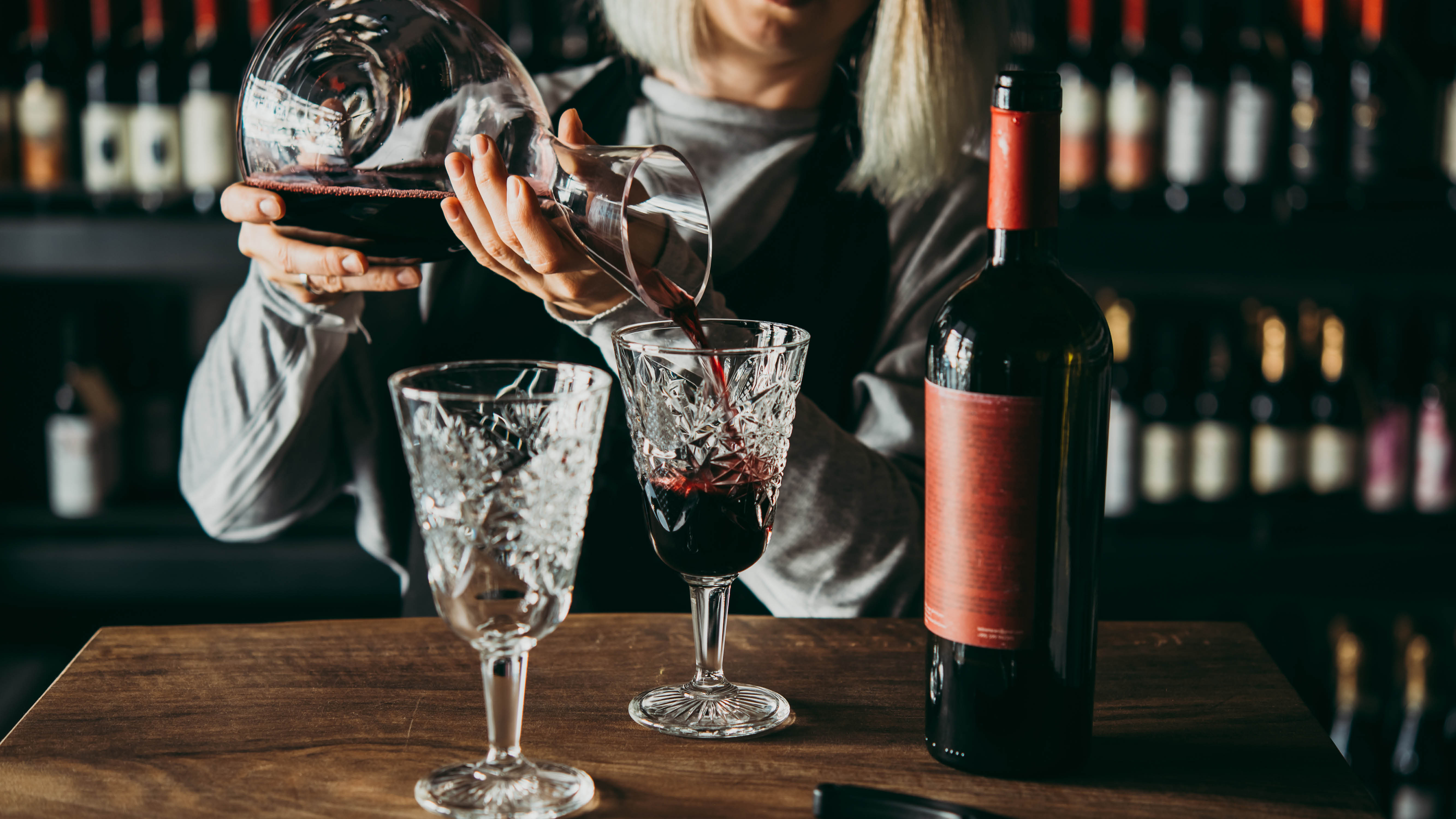lifestyle-woman-decanting-red-wine-into-glasses.jpg