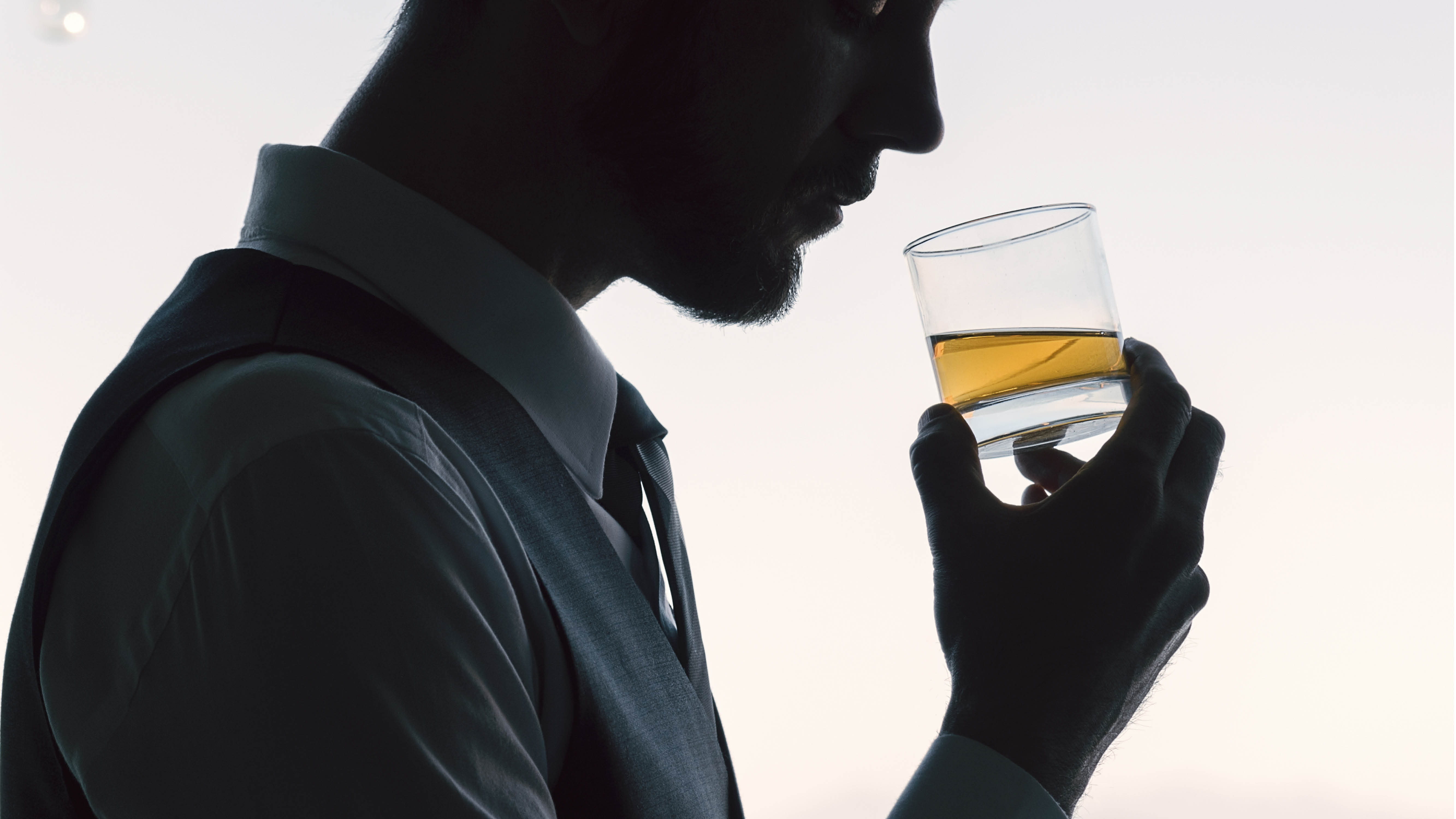 people-man-looking-down-towards-whisky-glass.jpg