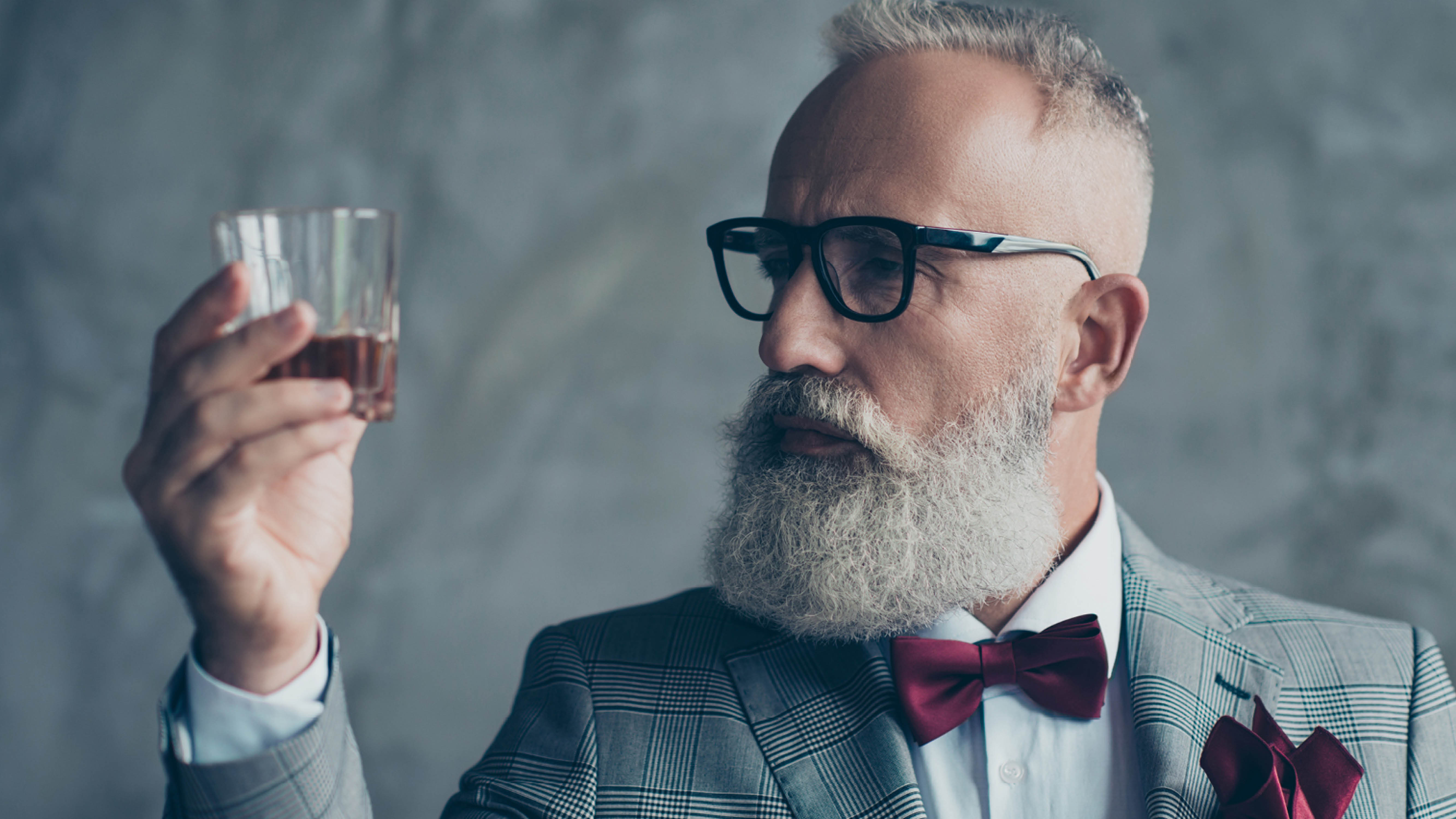 people-older-hipster-gentleman-looking-at-whiskey-glass.jpg
