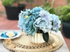 Sky Blue Open Rose and Mixed Flower Arrangement With White Ceramic Vase