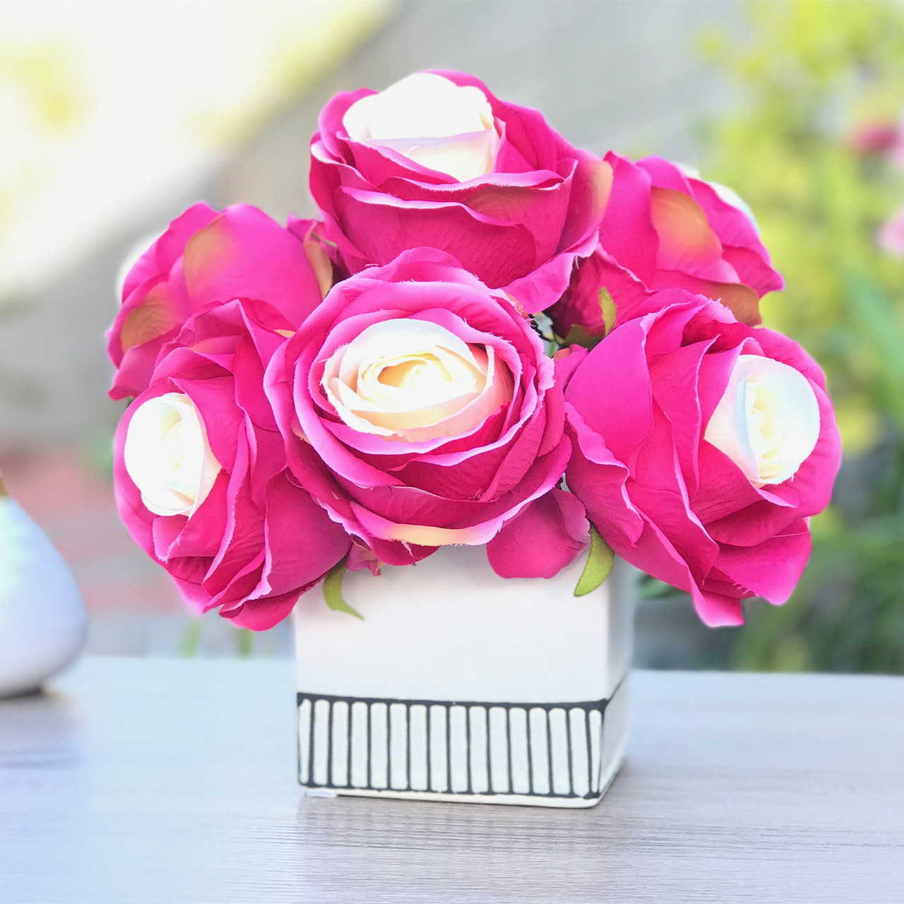 red artificial flowers in vase