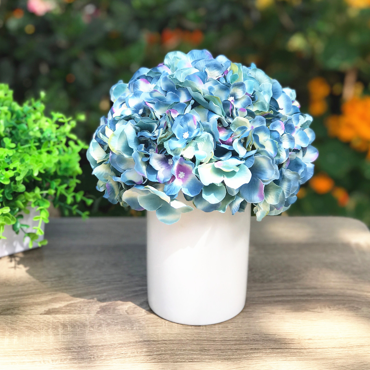 blue artificial flowers in vase