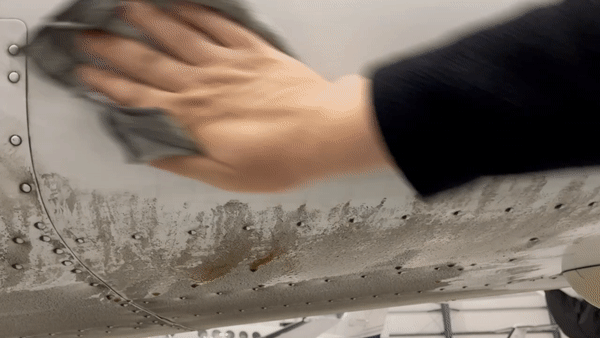 Release cleaner being used to wipe grime from an aircraft surface