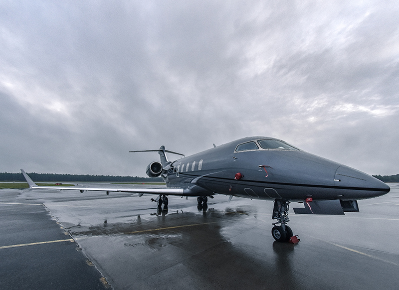 a gray private jet on a runway