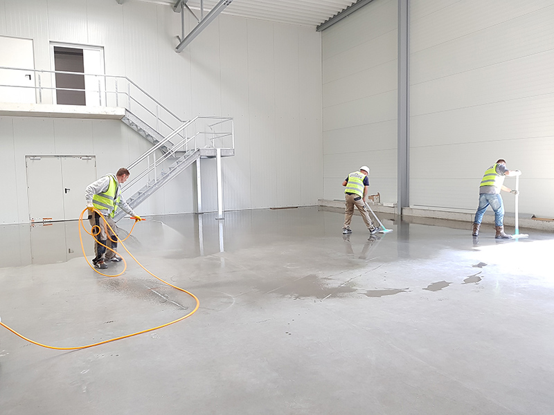 men cleaning warehouse floor