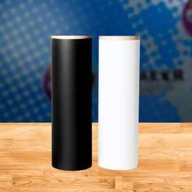 Rolls of black and white heat transfer vinyl (HTV) side by side on a flat surface.