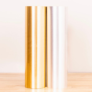 Rolls of POLI-FLEX Turbo Metallics HTV in 15" width, emphasizing its easy weeding and pressure-sensitive carrier for repositioning.