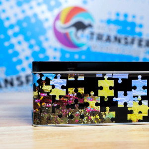Side view of the WALABlanks Metal Puzzle Tin on a wooden table