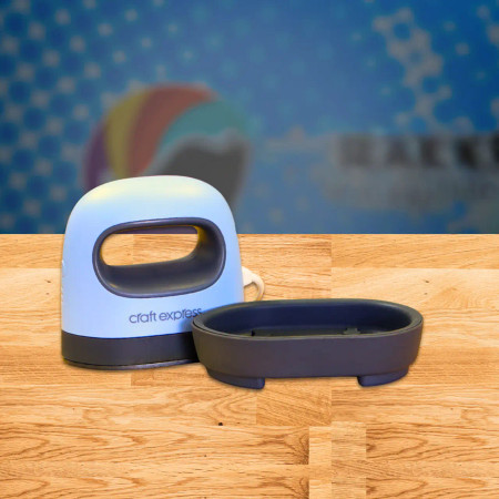 Craft Express Mini Crafting Heat Press next to it's heat protective base on table