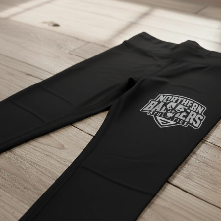 Flat lay of a pair of black spandex leggings showing a large, single-color gray stretch screen print transfer